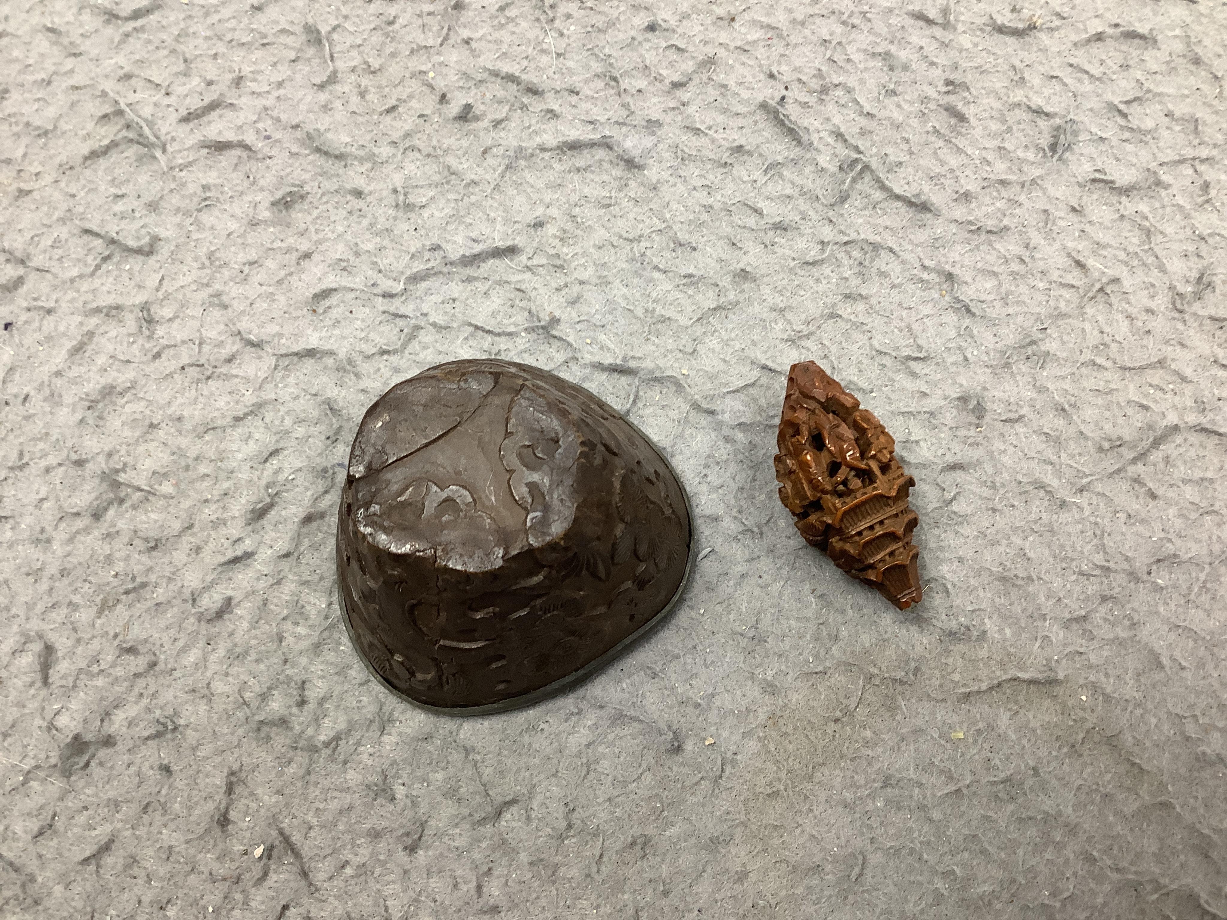 Four Chinese carved peach stones and an 18th/19th century Chinese carved wood cup, 6cm wide (5). Condition - fair to good